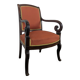 Restoration armchair in mahogany with cross arms and orange fabric.
