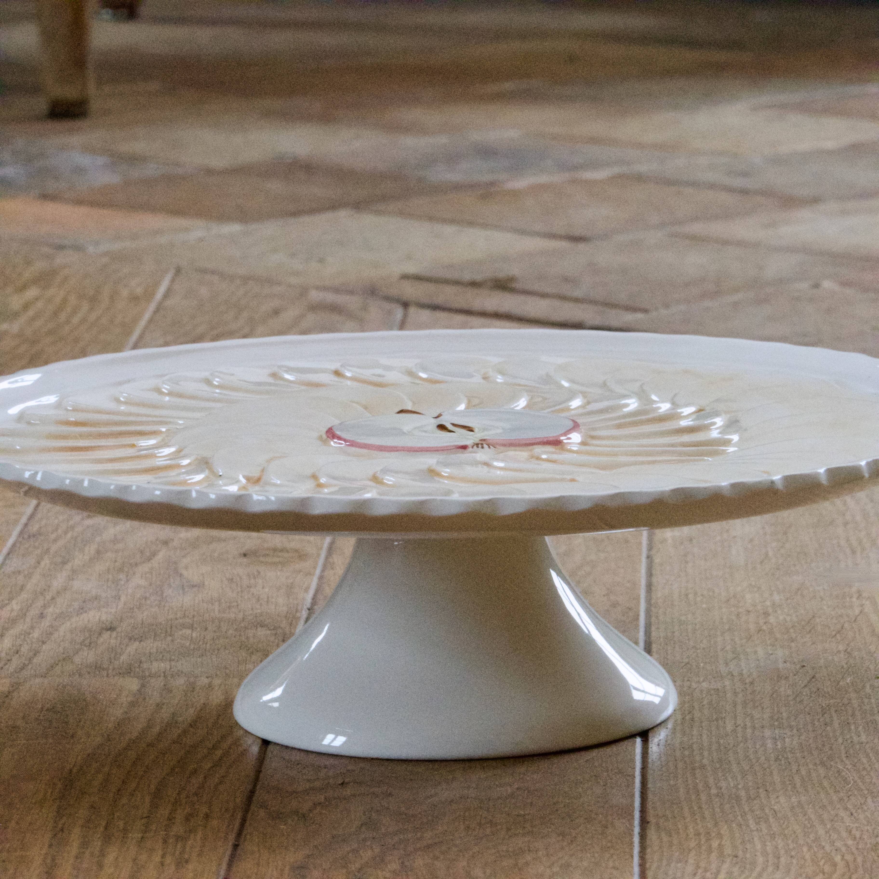 Large vintage earthenware pie dish on a pedestal, apple pie