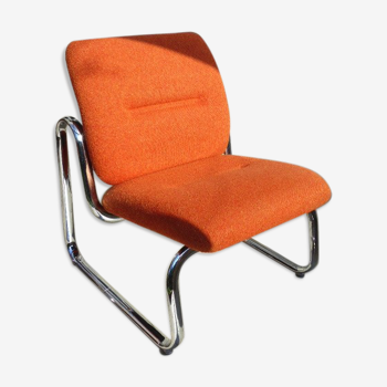 The 1970s orange armchair fabric and chrome metal