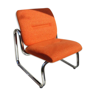The 1970s orange armchair fabric and chrome metal