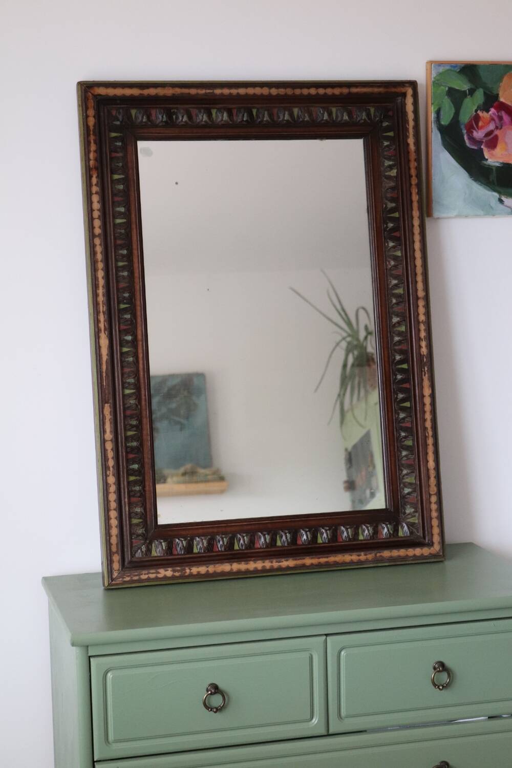 Antique mirror with a carved and painted wooden frame