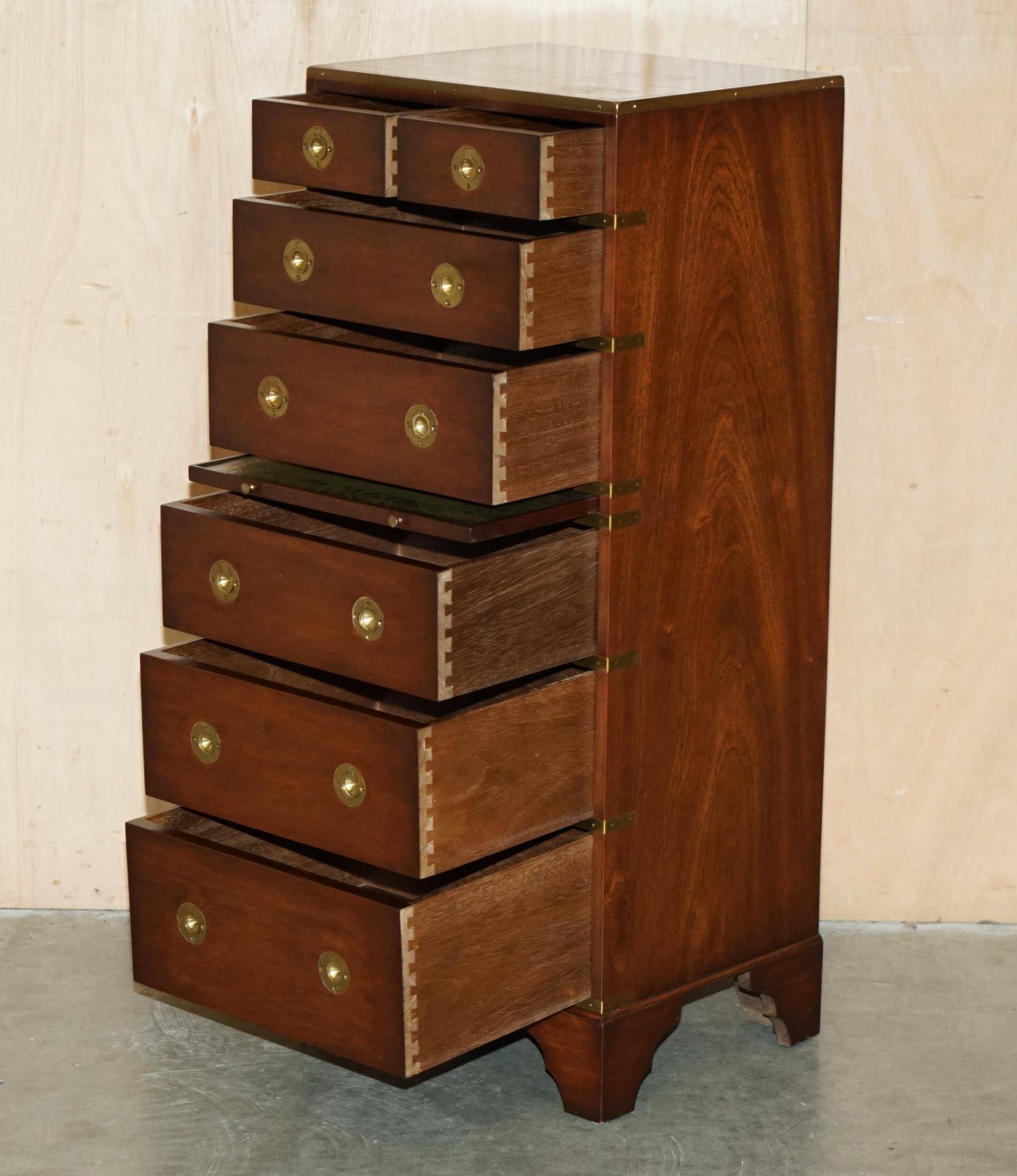 Pair of vintage military campaign high chests of drawers with leather tops.