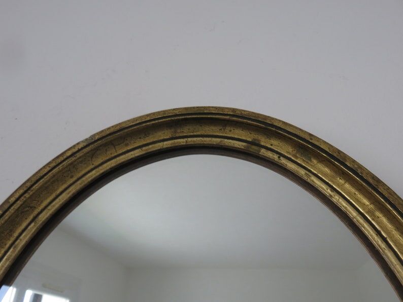 Old oval mirror in gilded wood 50s 60s