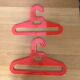 Pair of vintage orange hangers Prisunic