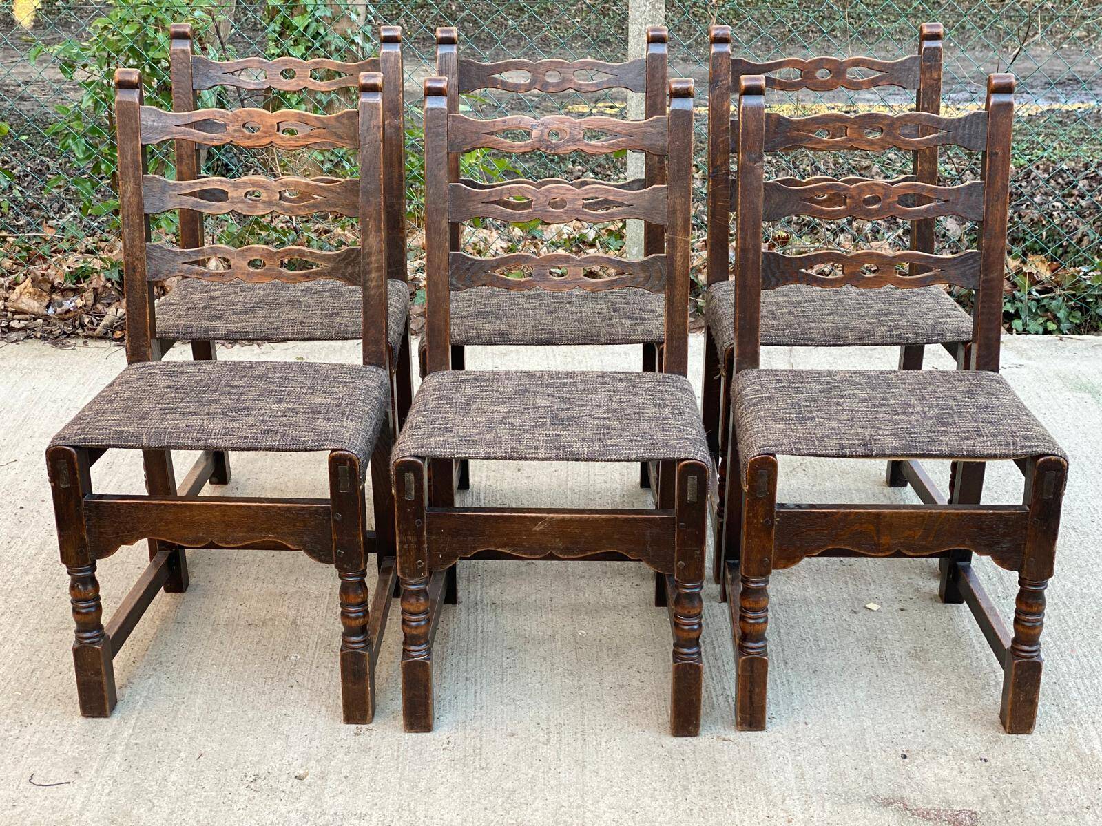 6 solid wood dining chairs with grey woven wool seats.