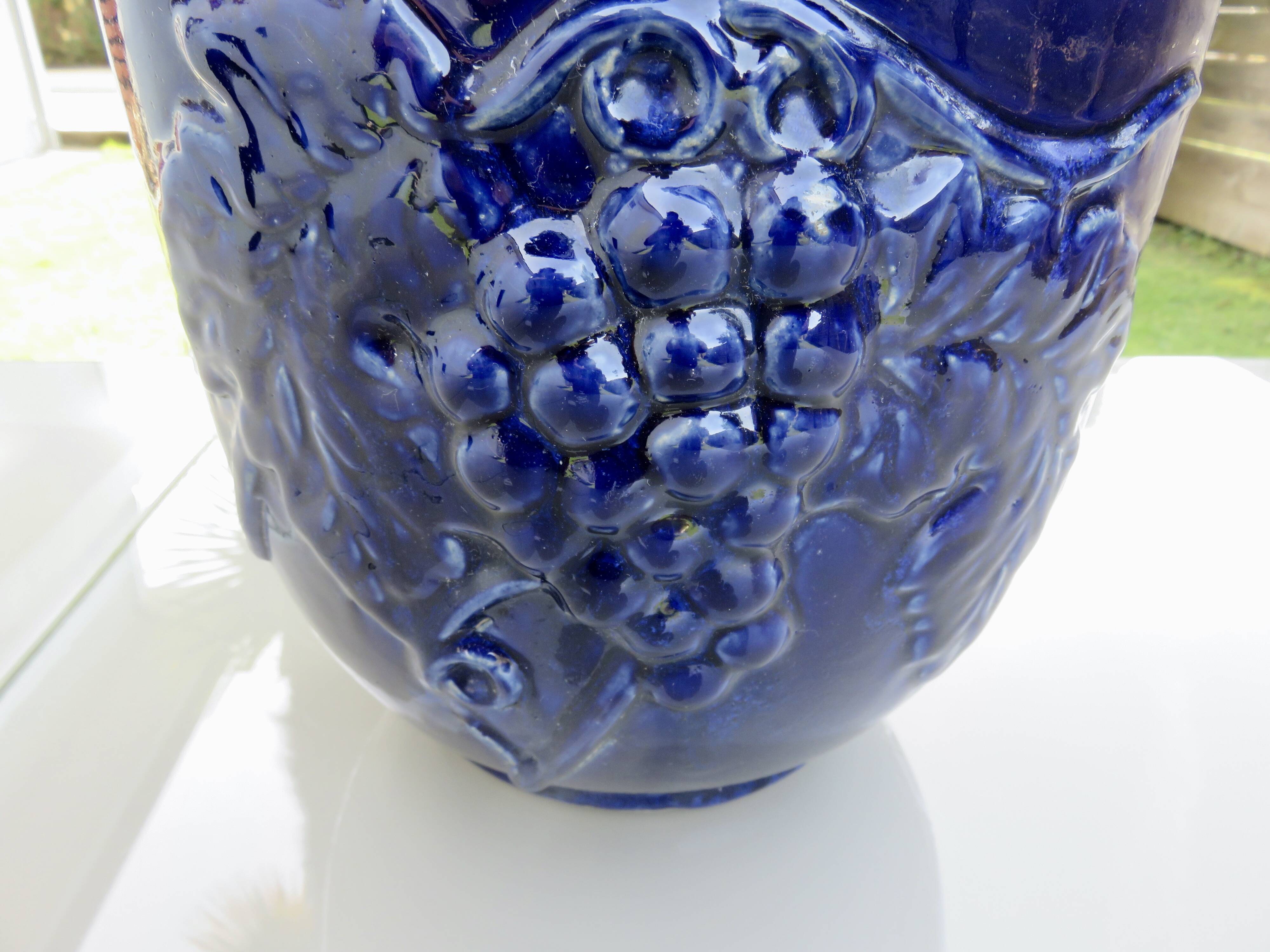 Wall pot in glazed blue terracotta with a grape motif, 1970s.