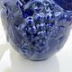 Wall pot in glazed blue terracotta with a grape motif, 1970s.
