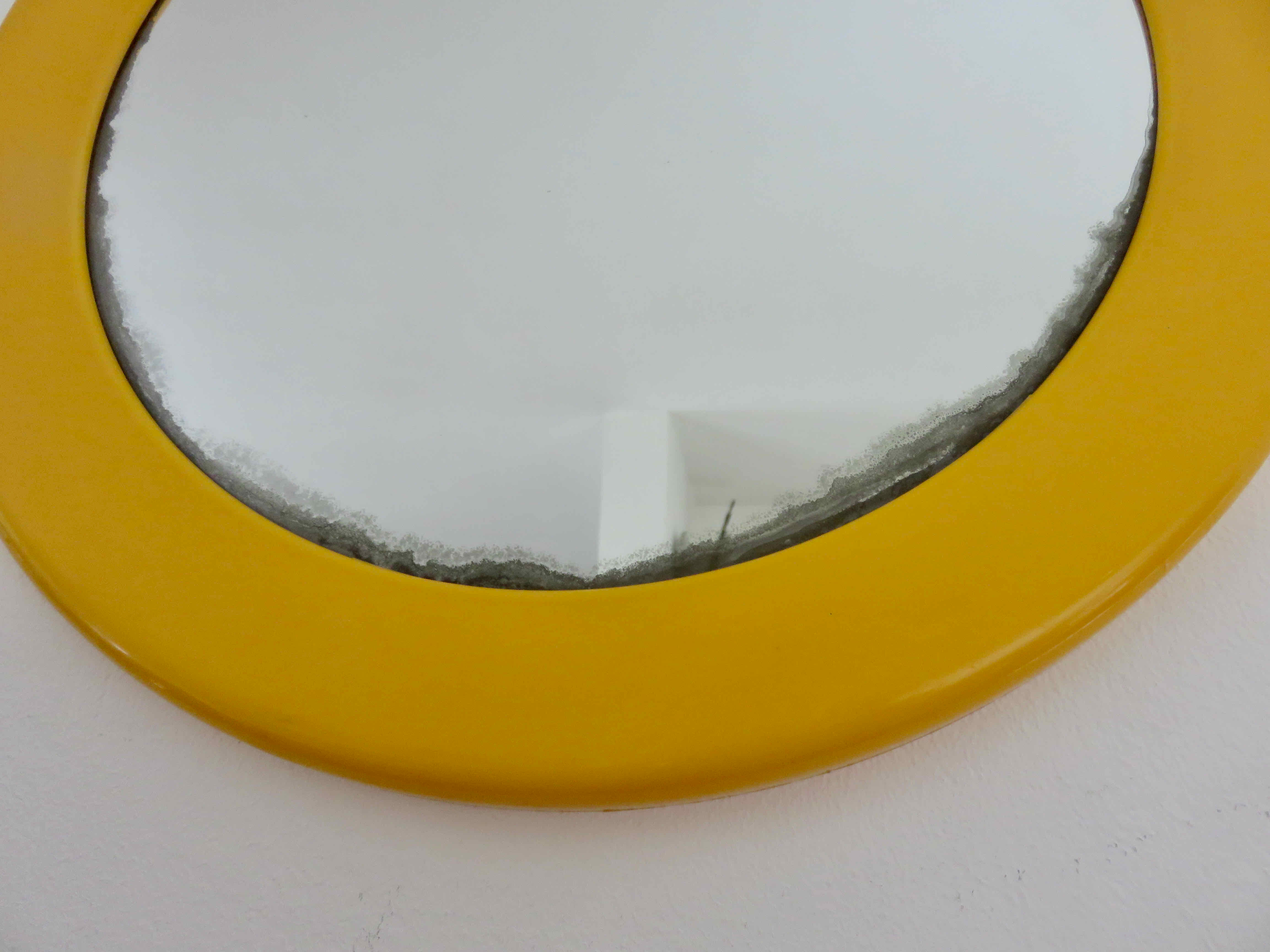 Round wall mounted mirror in yellow plastic 1970