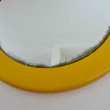 Round wall mounted mirror in yellow plastic 1970