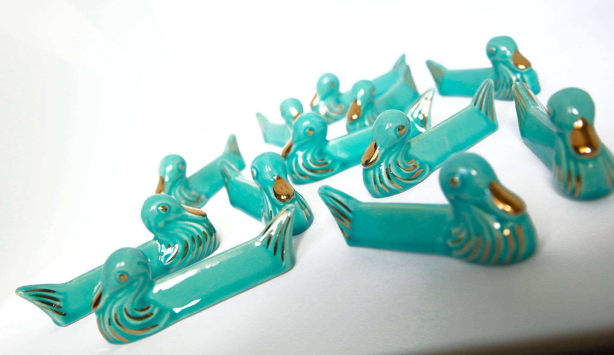 Set of 12 turquoise blue and gold duck knife holders mid-20th century