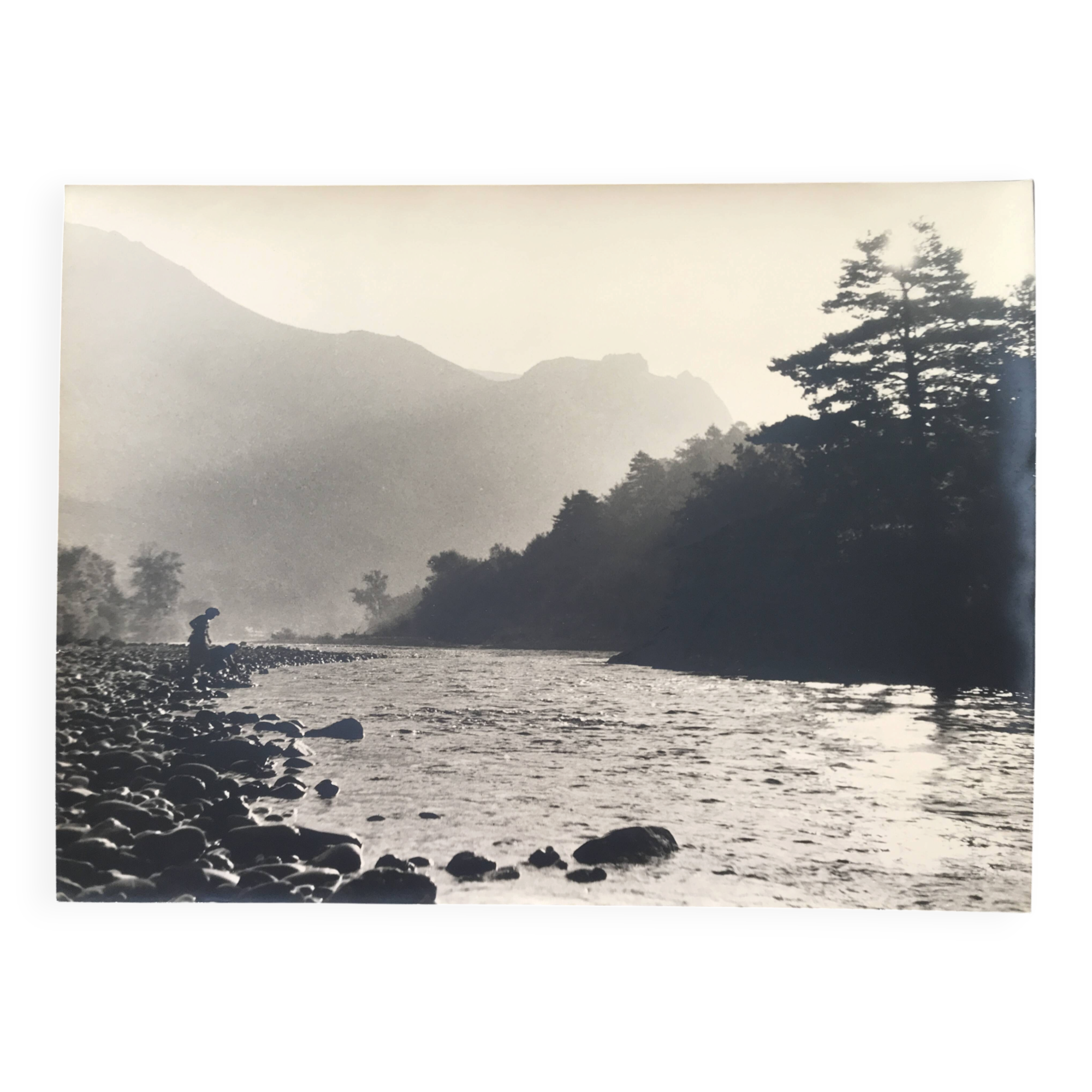 River landscape with characters, 60s/70s. Black and white silver print.