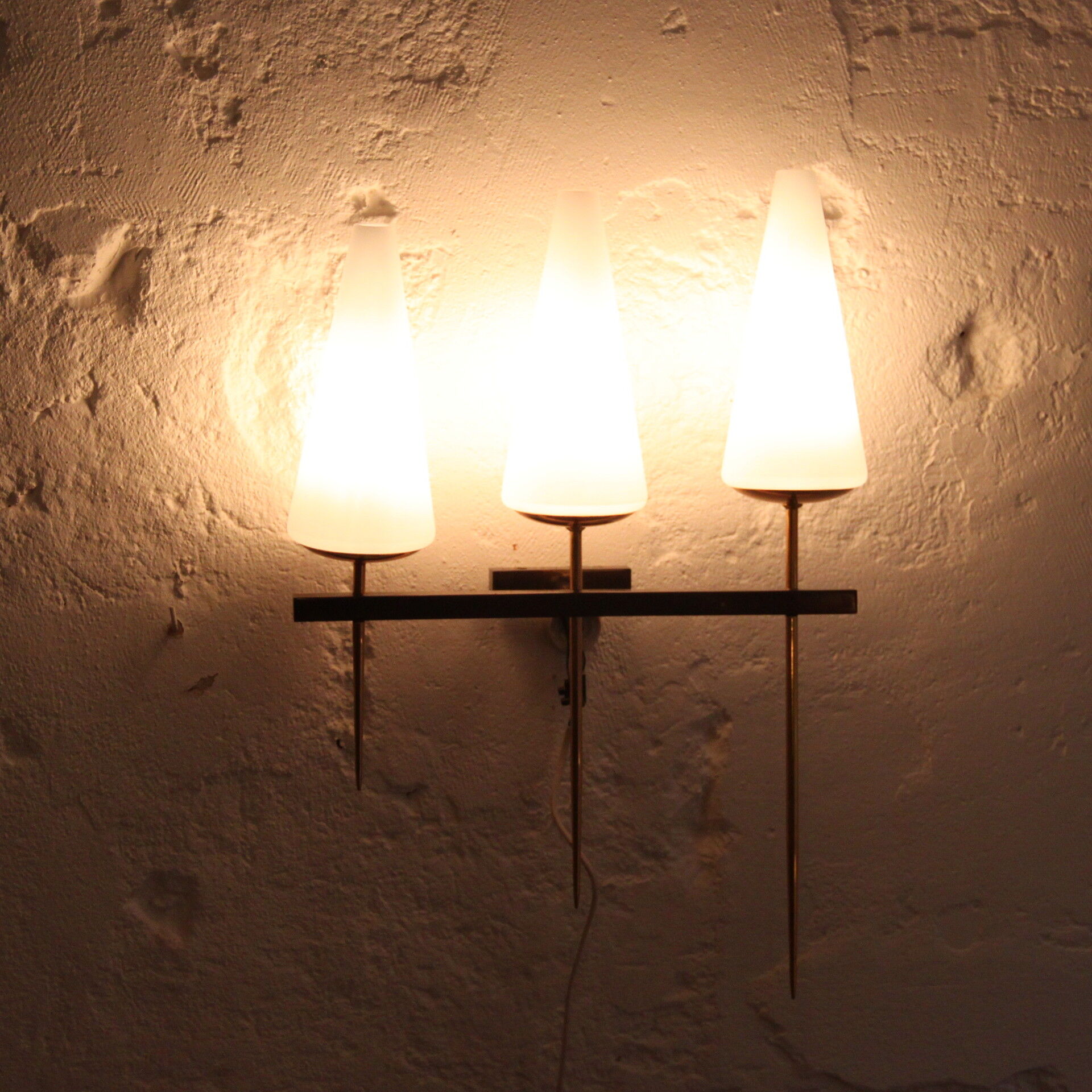 Old wall in brass and white opaline glass tulip