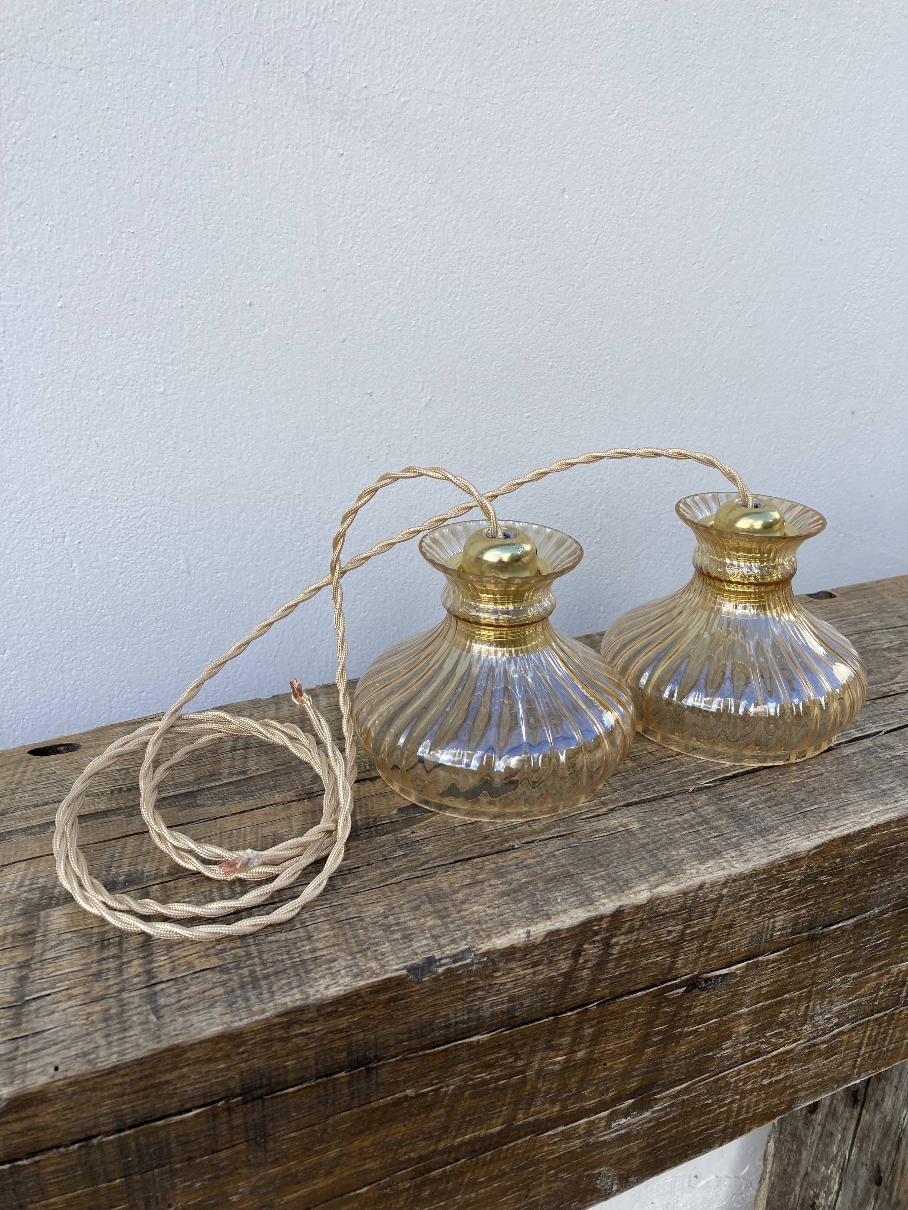 Pair of amber glass walkmen to hang in suspension
