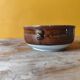 Old small glazed ceramic dish with lion head decoration - brown enamel kitchen bowl