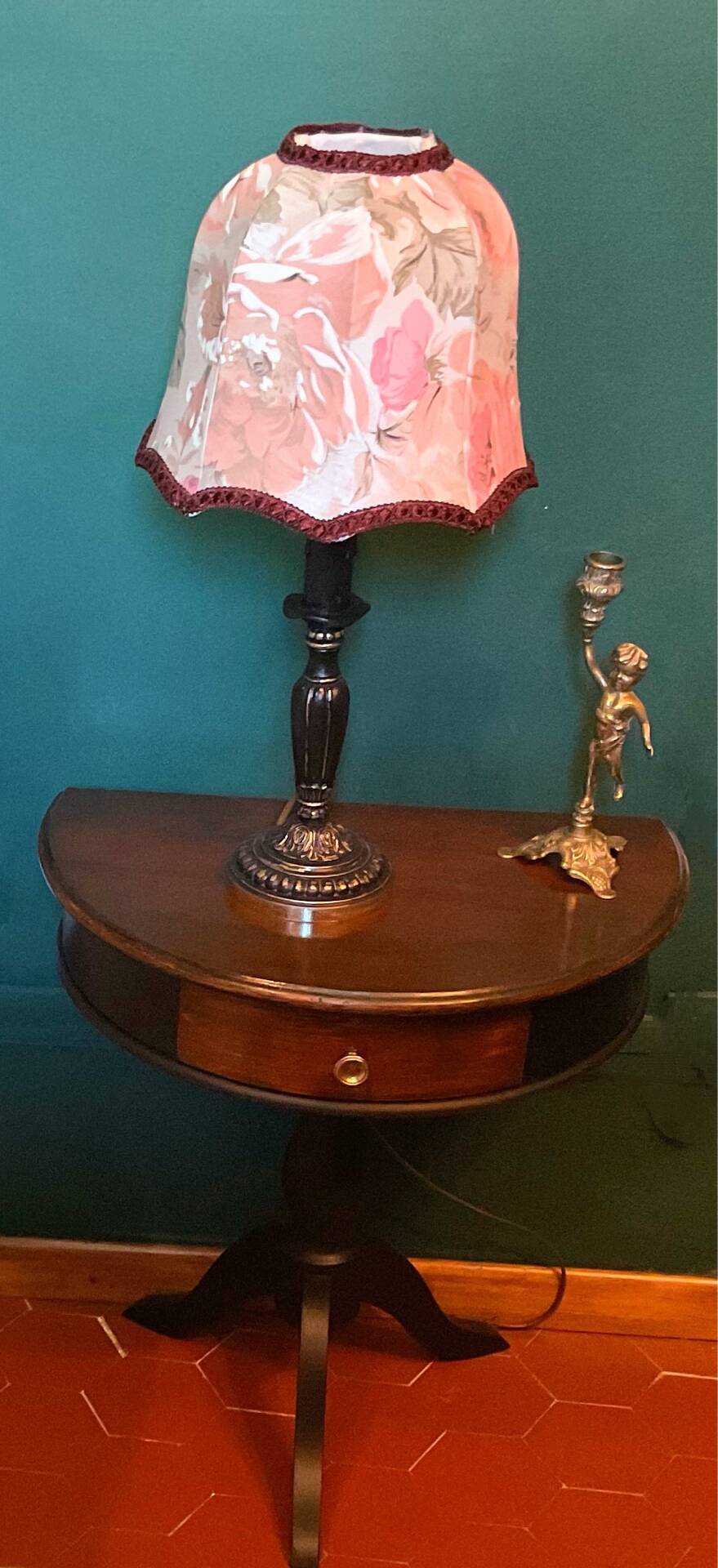 Antique half-moon side table in wood and black.