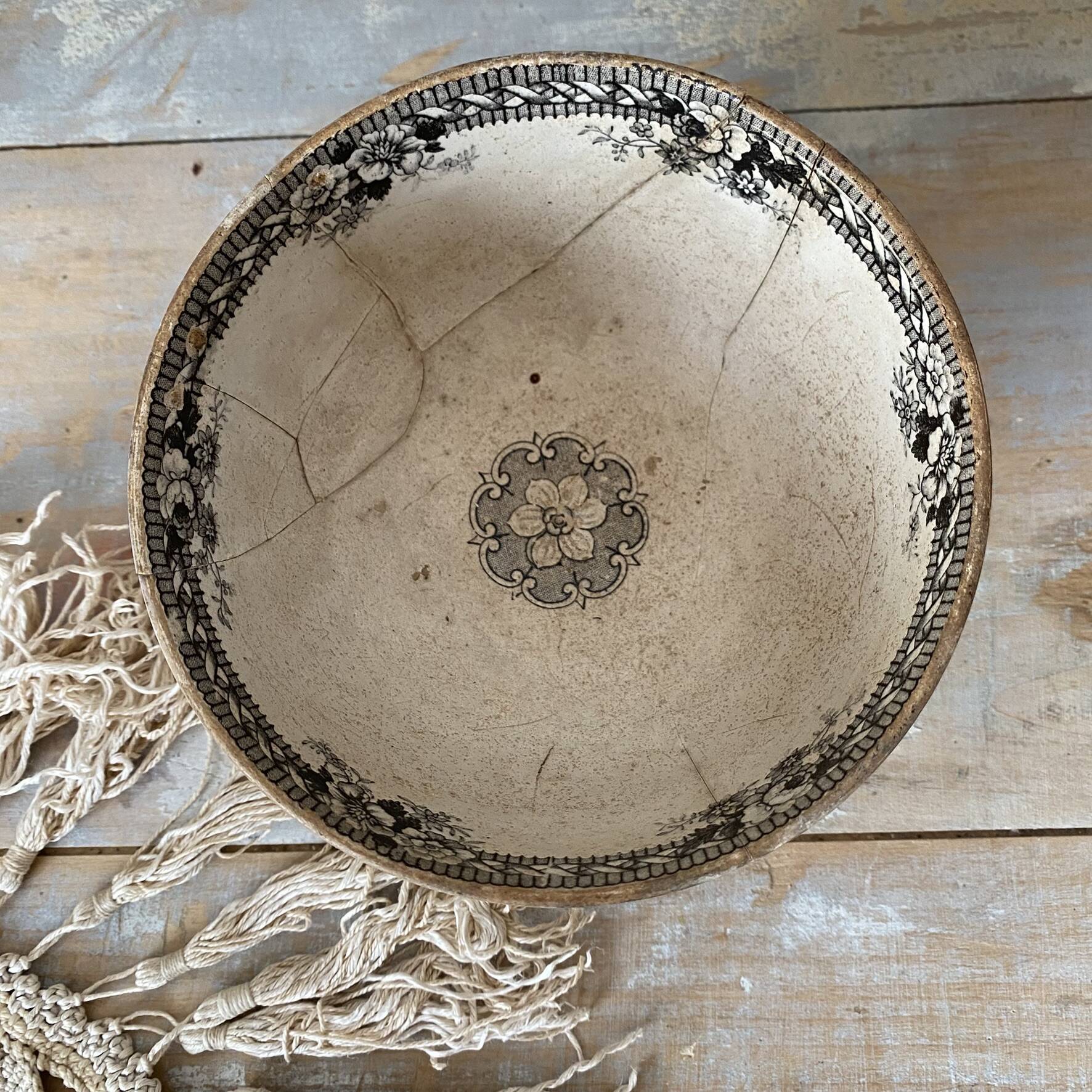 Old bowl made of iron with ceramic seams.