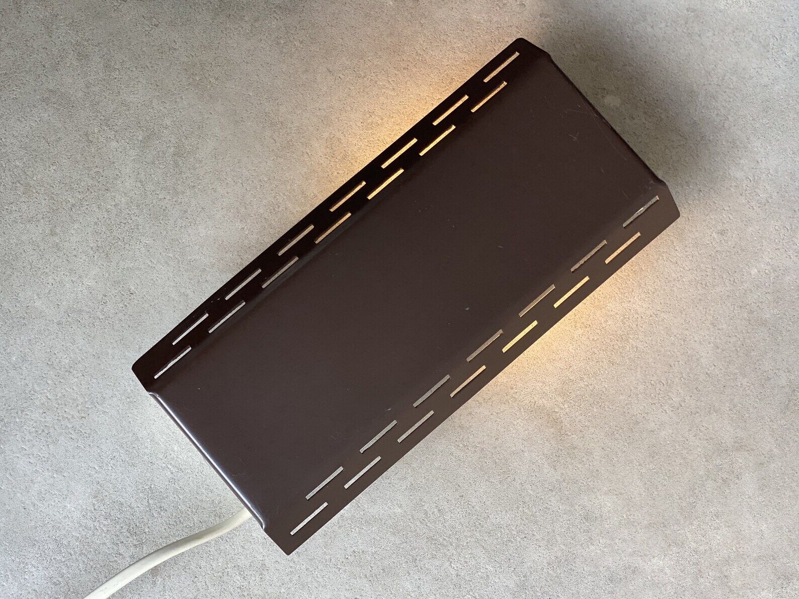 Wall sconce with a perforated shade
