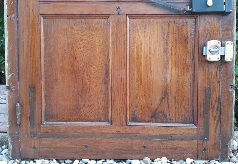 Oak entrance door and its frame and transom, wrought iron gates