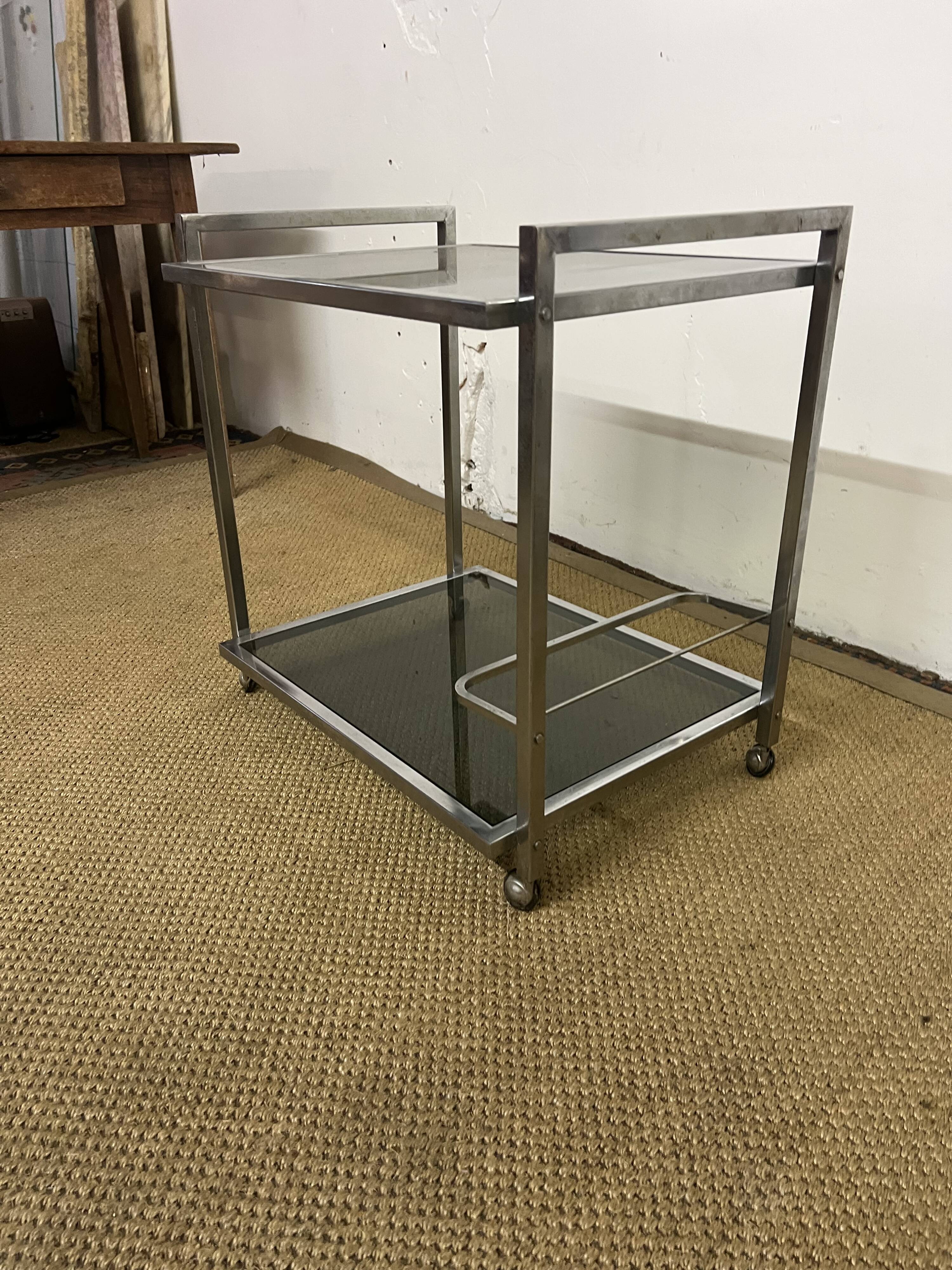 1970s coffee table in brass with a double smoked glass top.