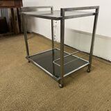 1970s coffee table in brass with a double smoked glass top.