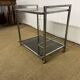 1970s coffee table in brass with a double smoked glass top.