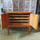 Vintage storage unit with two doors and four drawers.