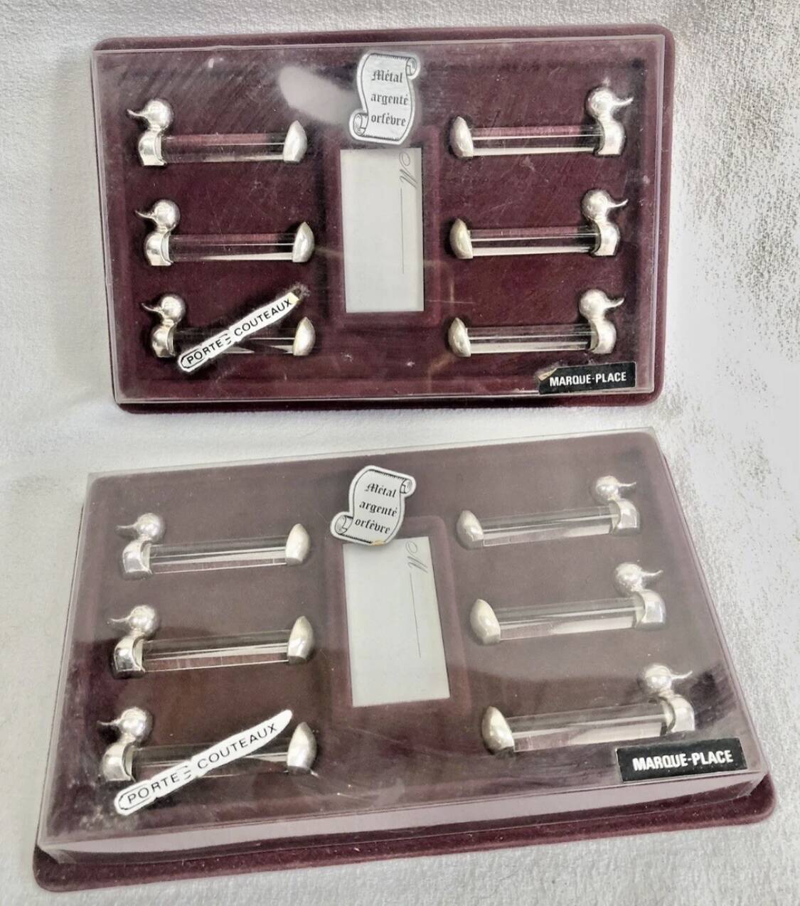 12 silver-plated metal duck knife rests with crystal.