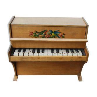 Ancient toy, wooden piano, decorating birds on rose bush