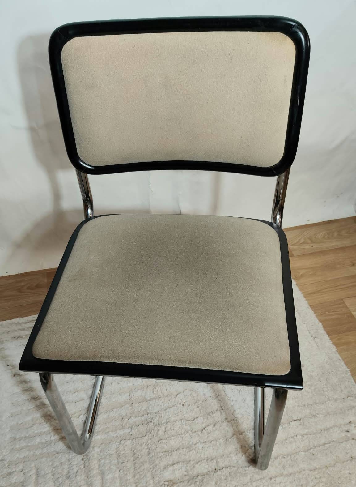 Cesca B32 chair by Marcel Breuer, upholstered in beige fabric.