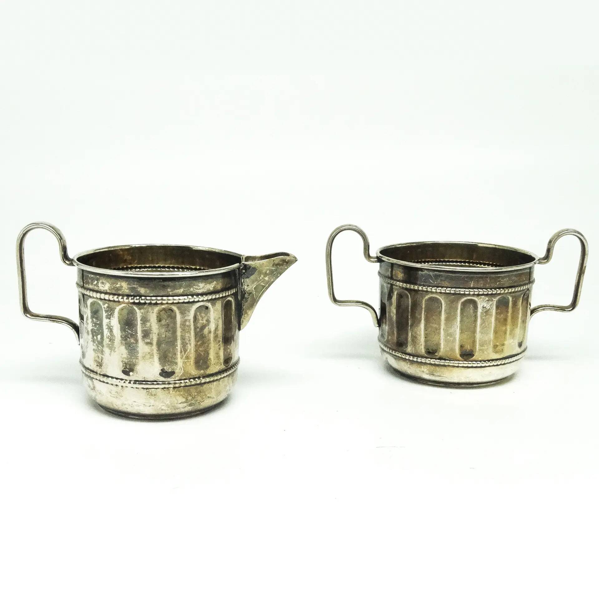 Set of sugar bowl and milk jug, neoclassicism with art deco influences, silver-plated brass, Belgium, 1930s.