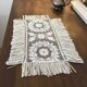 Old napperon in knotted and hand-embroidered fillet