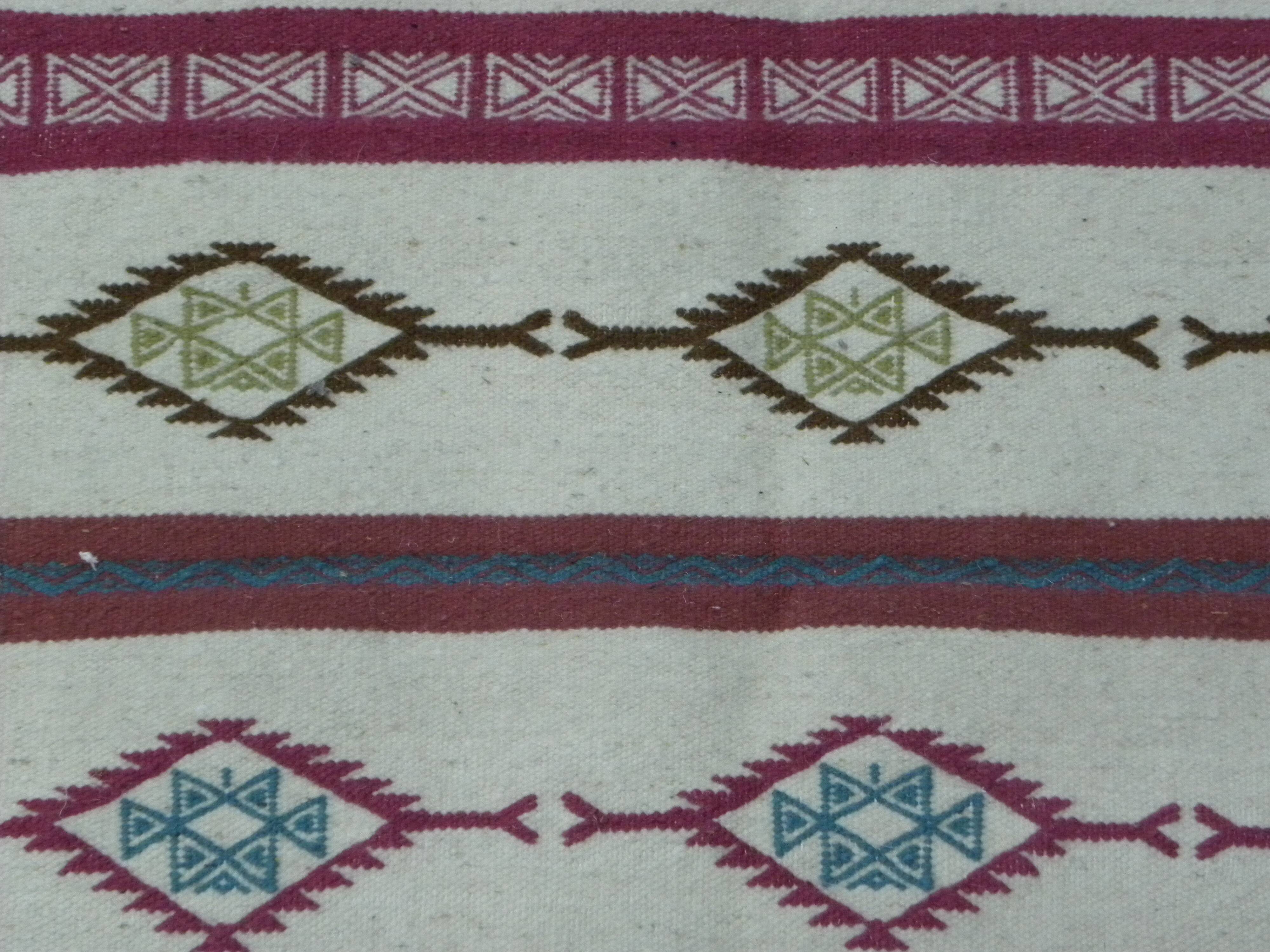 Tribal bohemian kilim rug with geometric pattern in wool.