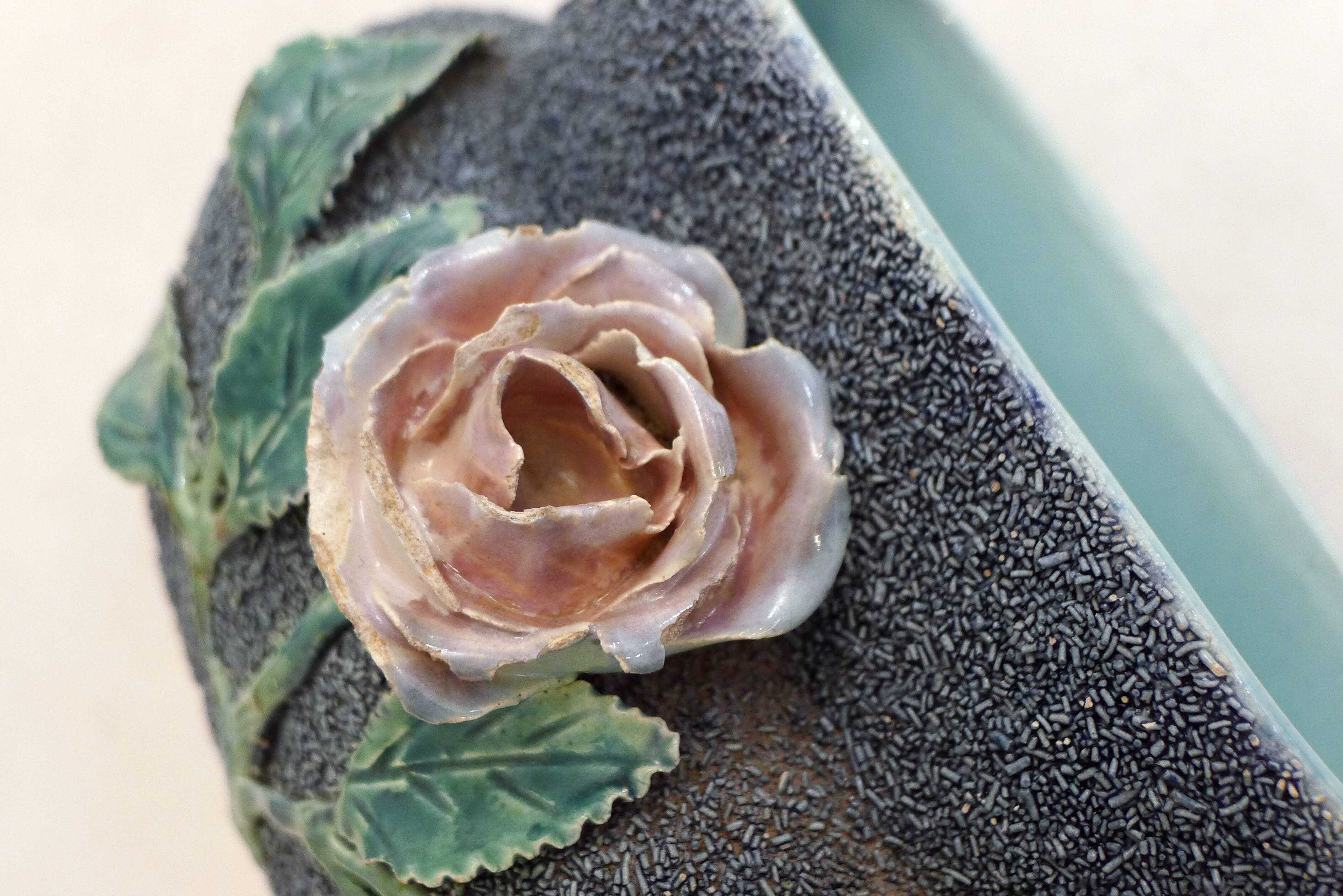 Antique jardinière with rose design in barbotine pottery.