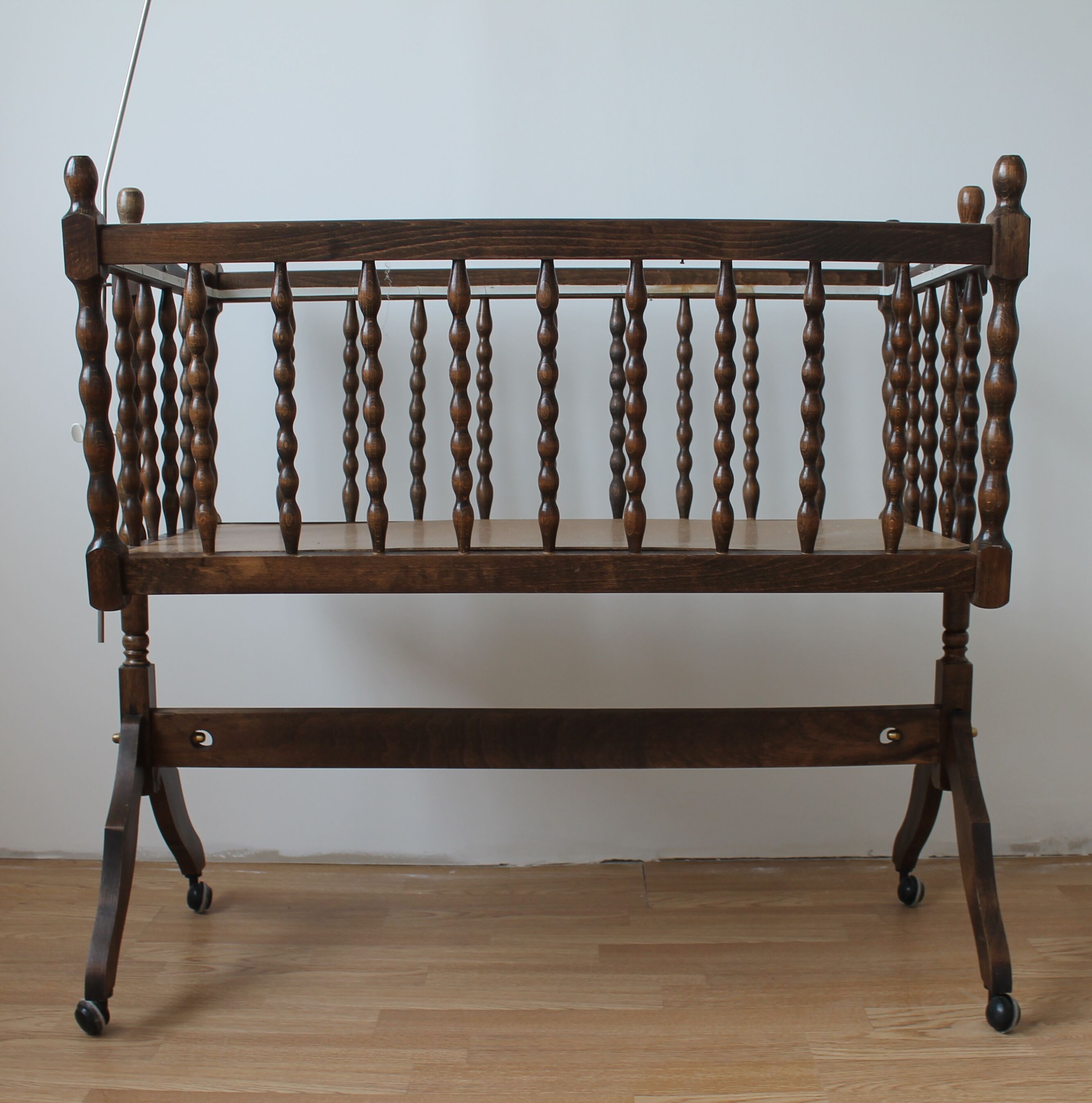 Old Vintage cradle with balance on wheels
