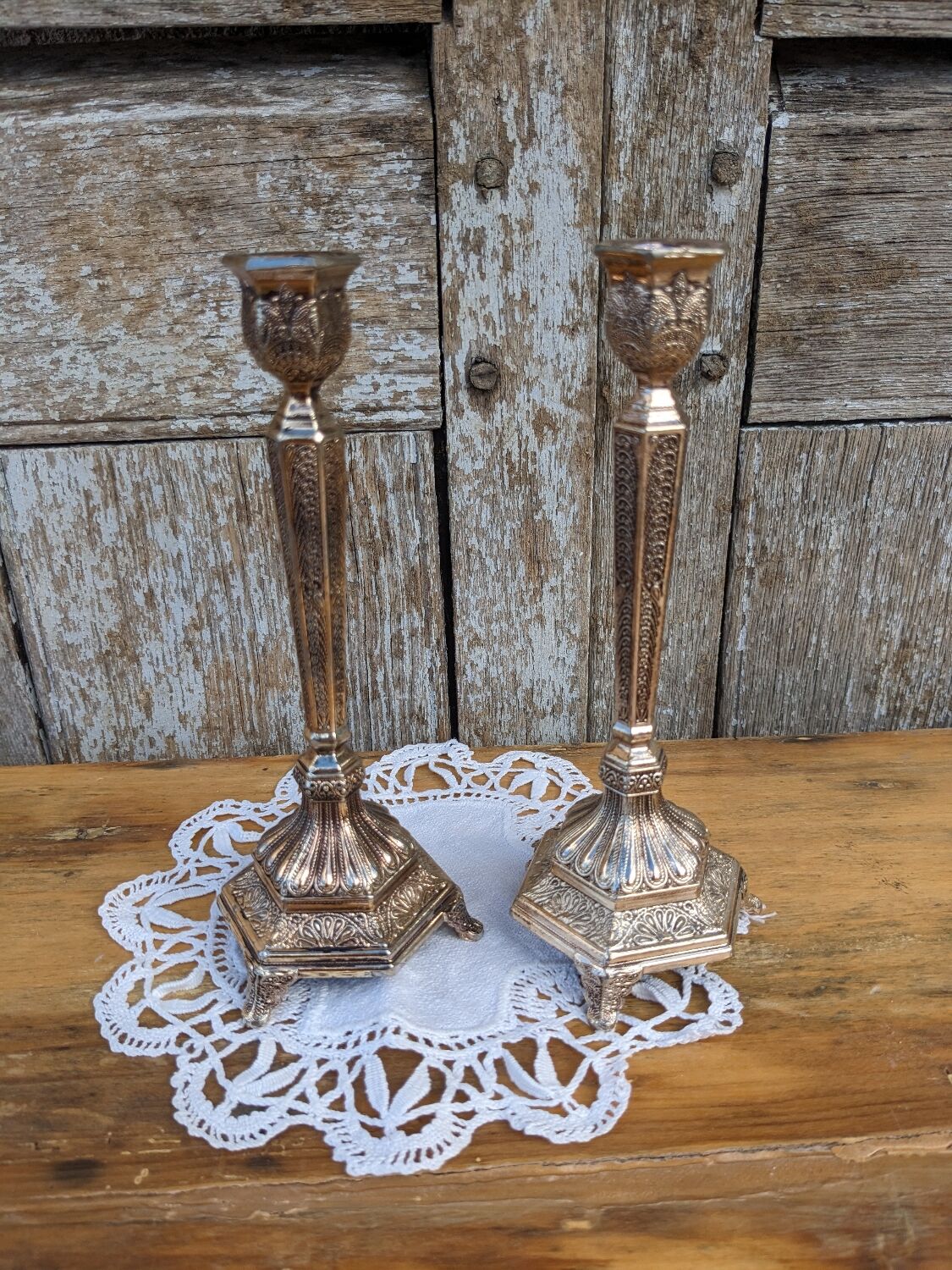 Pair of chiseled metal candle holders