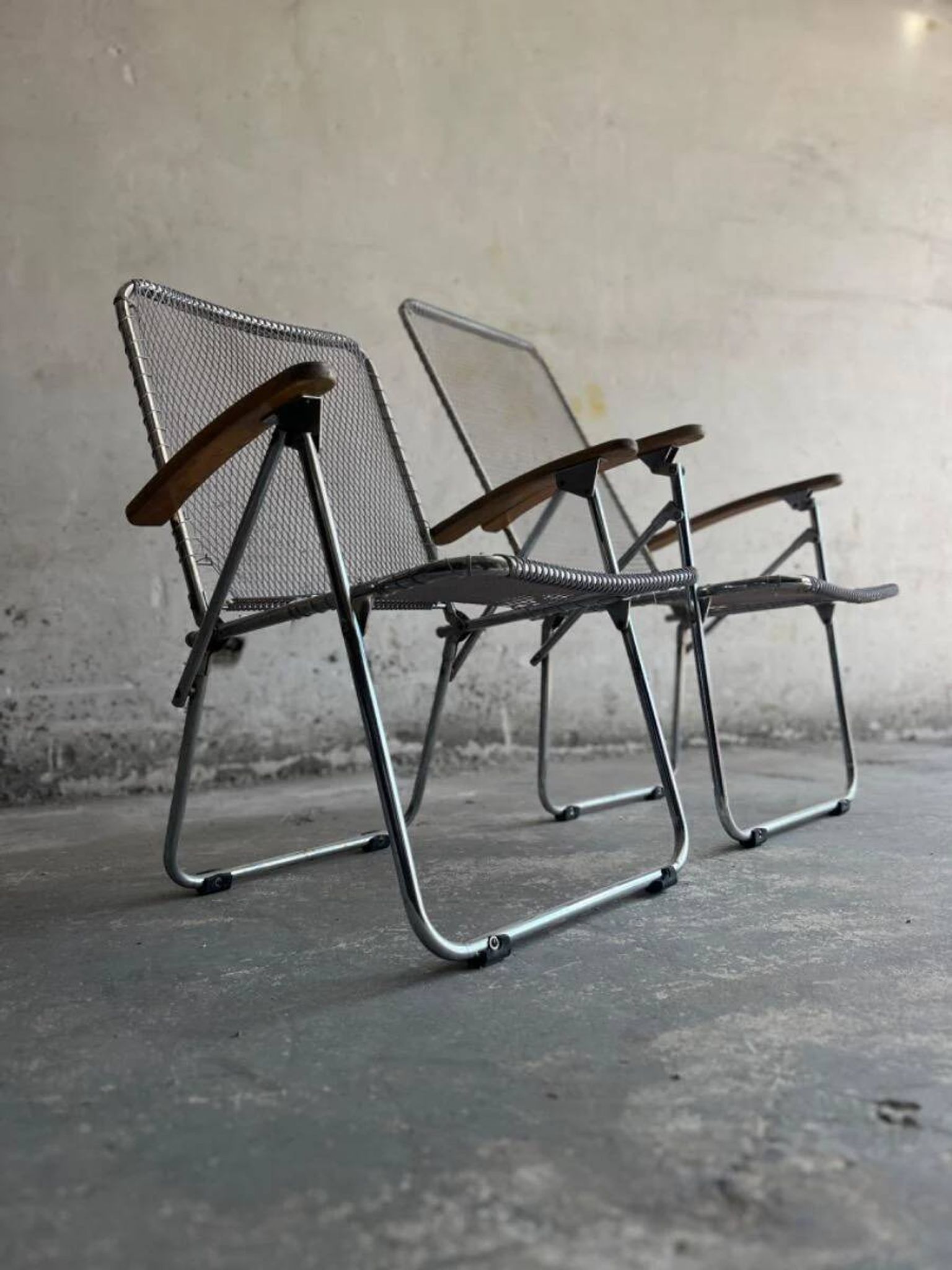Set of two vintage folding chairs with an aluminium wire frame.