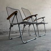 Set of two vintage folding chairs with an aluminium wire frame.