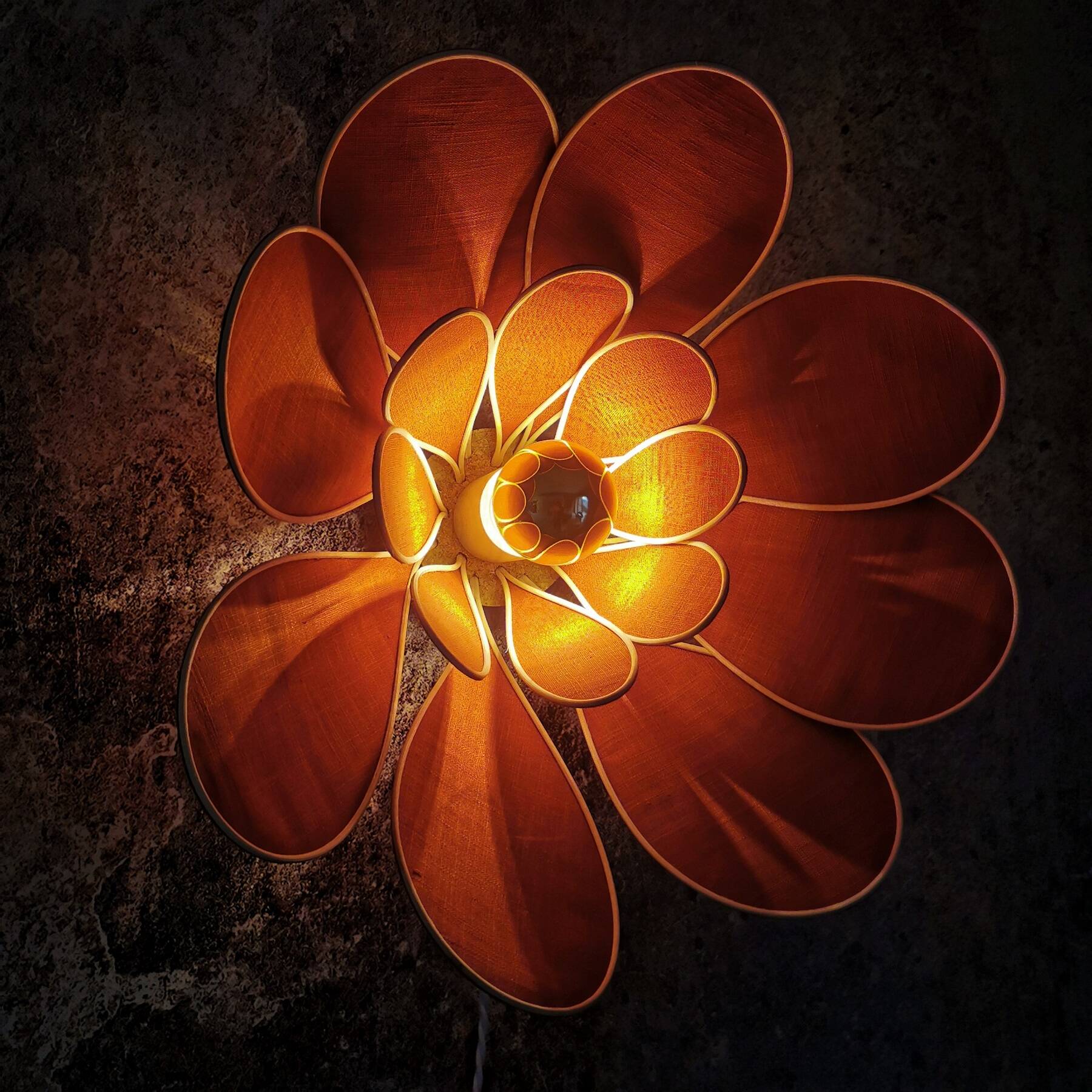 Flower wall light made of rattan and terracotta linen petals