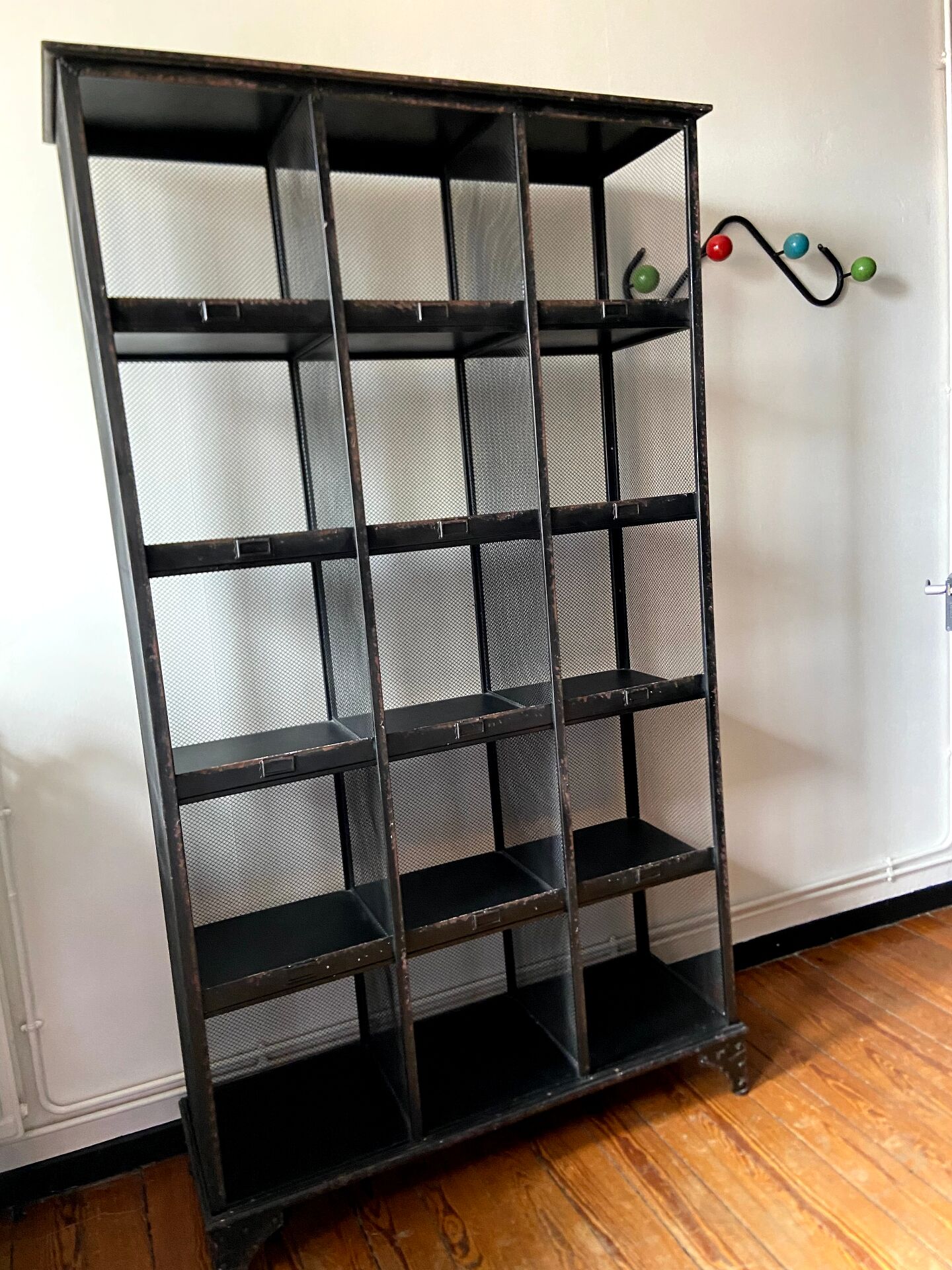 Black metal shelf with compartments.