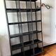 Black metal shelf with compartments.