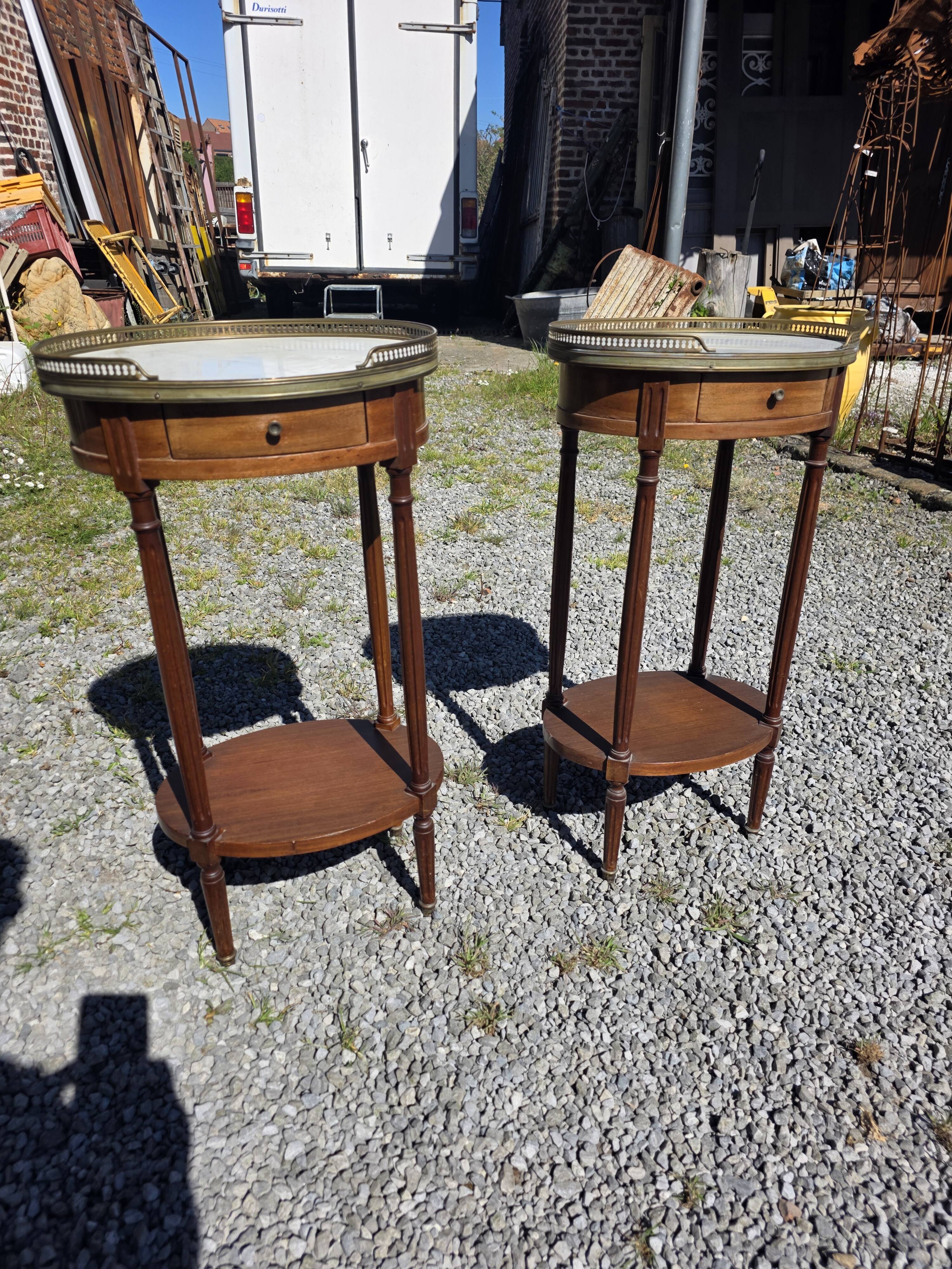 Pair of Louis XVI style bedside tables in mahogany, with marble tops.