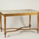 Golden carved wooden centre table with a white marble top.