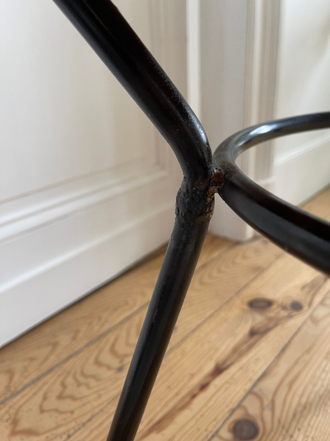 Tripod coffee table with a straw covering.