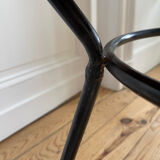 Tripod coffee table with a straw covering.