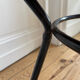 Tripod coffee table with a straw covering.