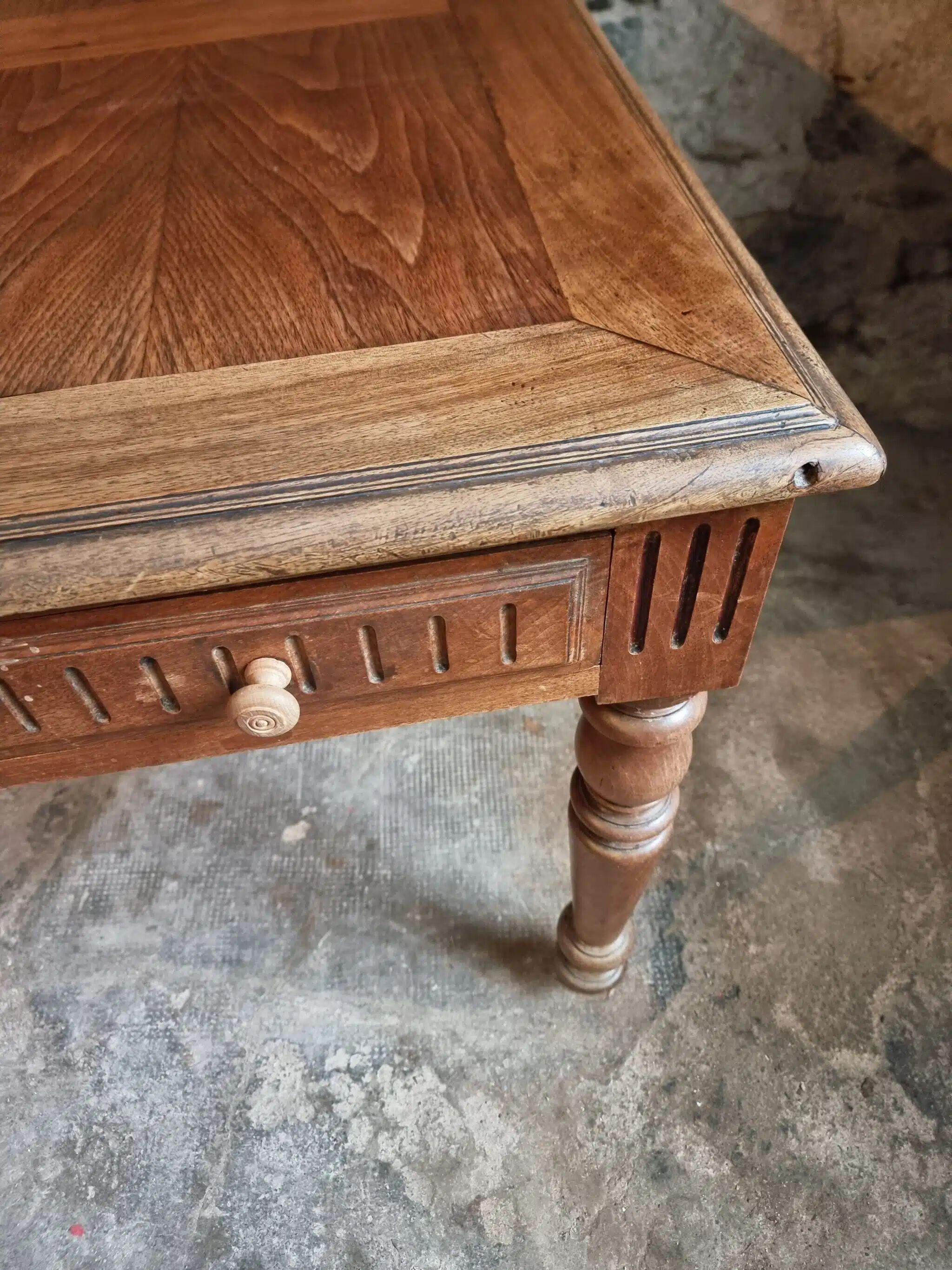Antique French walnut table with six drawers, parquet top, early 20th century.