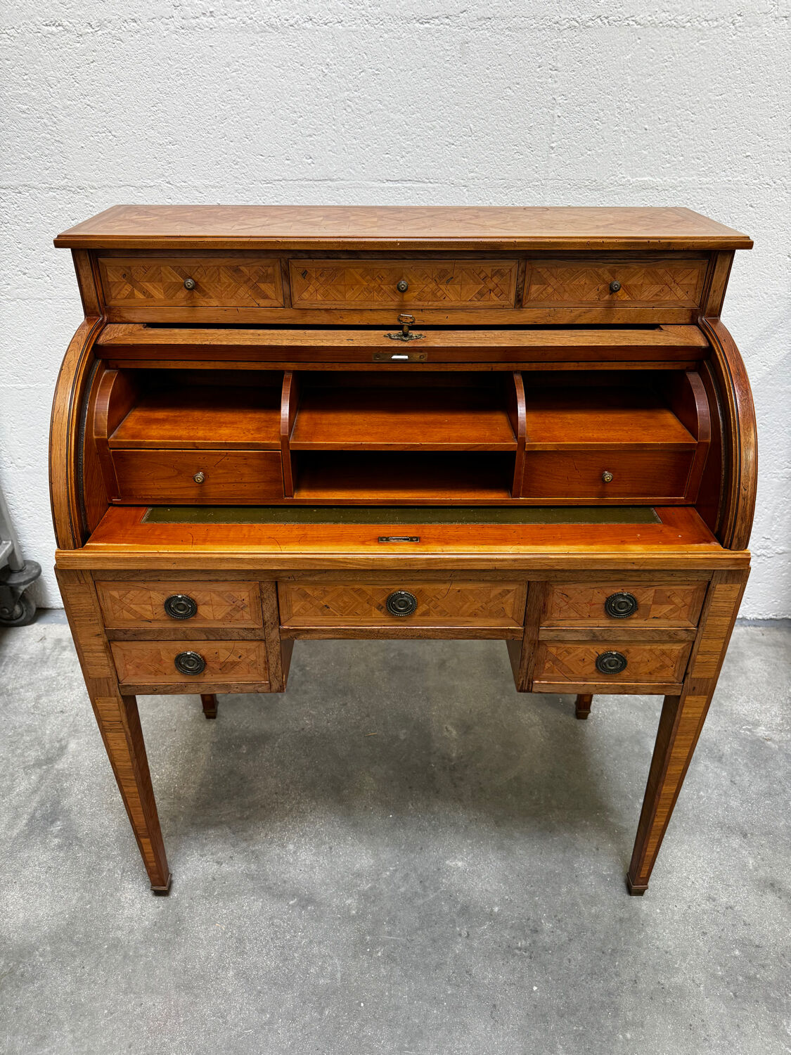 Cylinder desk with marquetry featuring a crosshatch design.