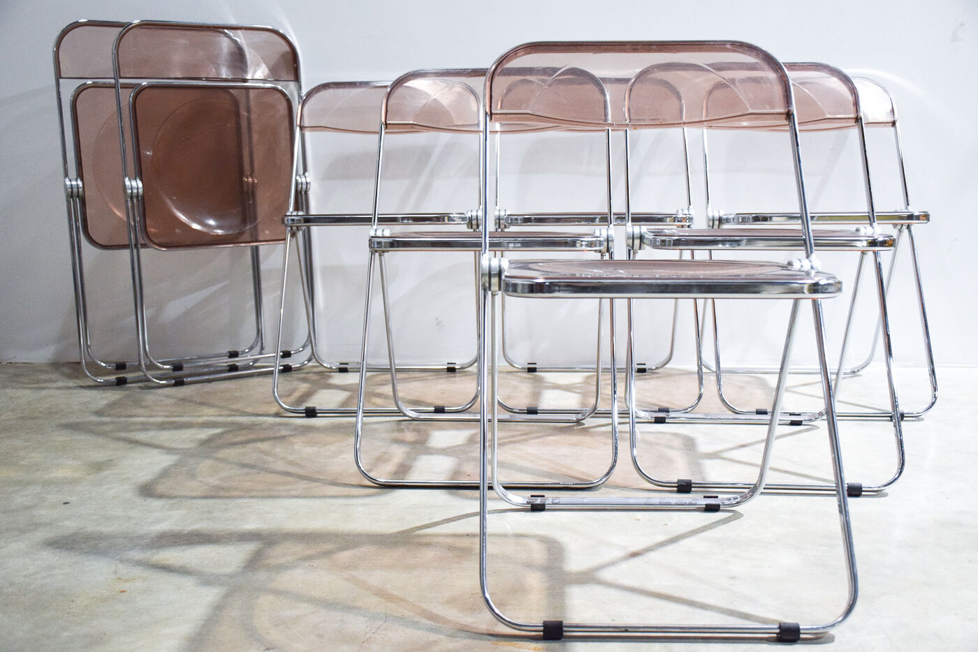 Set of eight pink Plia chairs by Giancarlo Piretti for Castelli