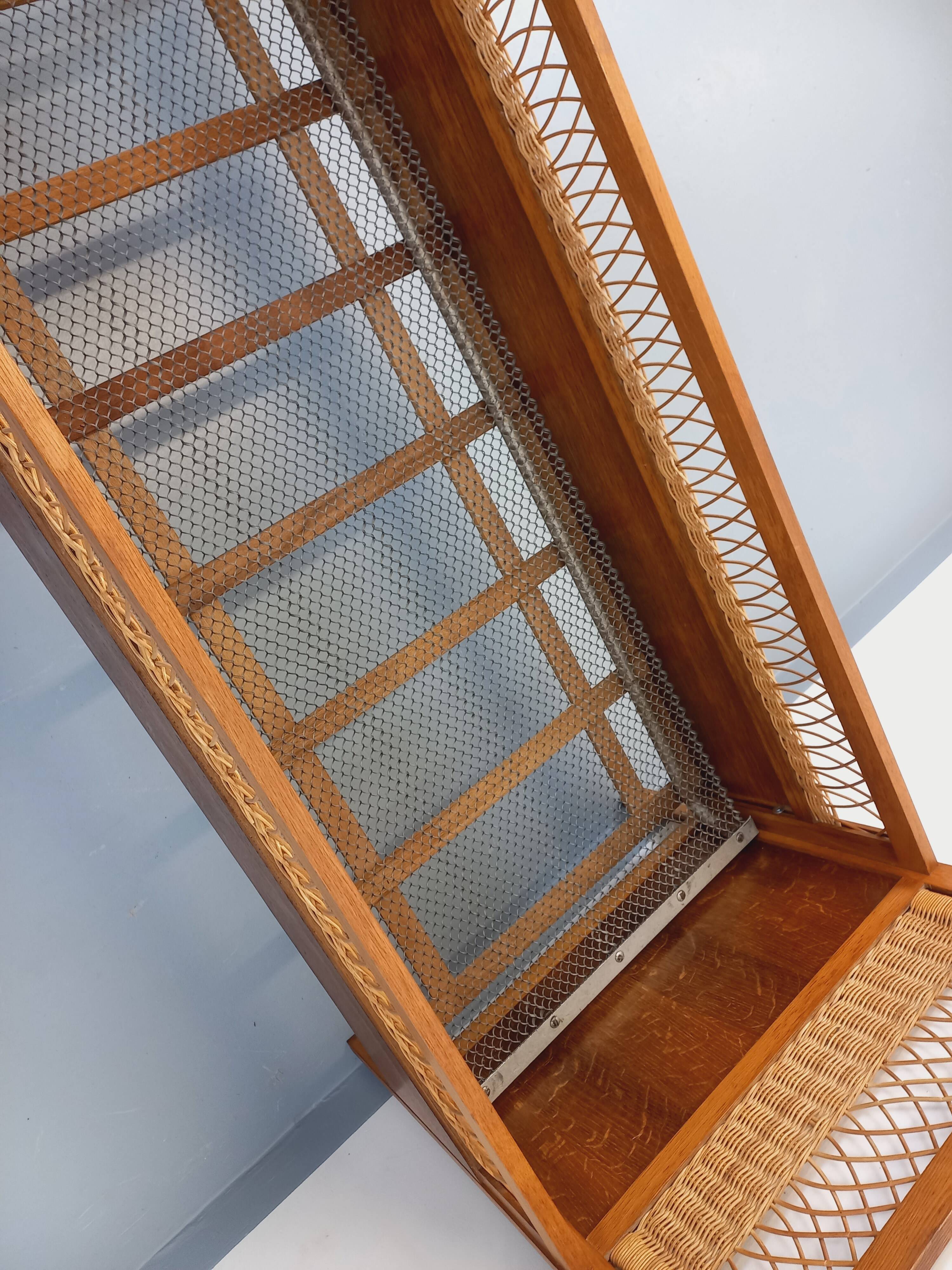 Vintage oak and rattan baby cot from the 1960s.