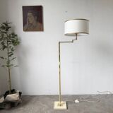 Floor lamp with articulated arm in brass-plated metal
